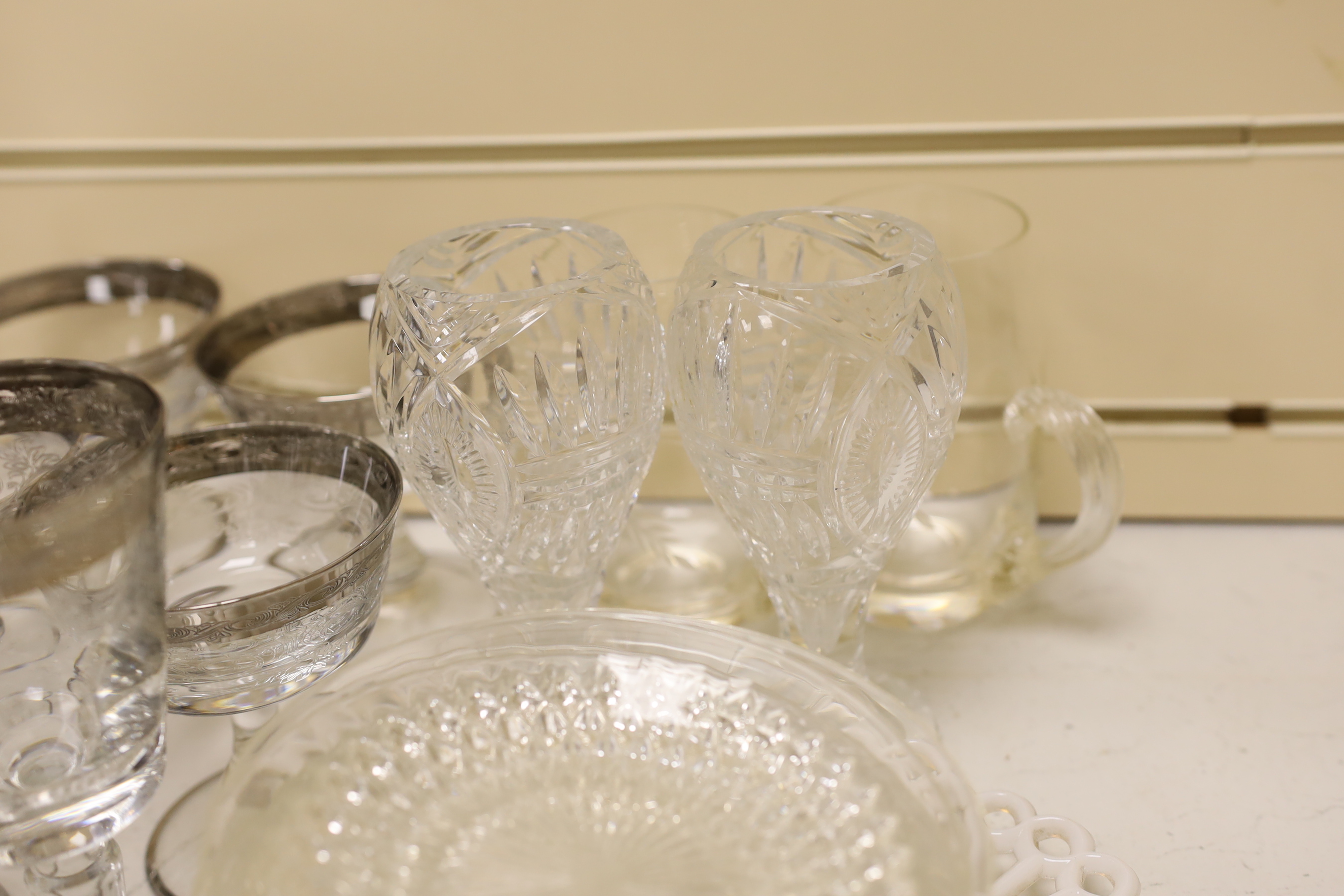 A part suite of etched and silver banded wine glasses together with other glassware